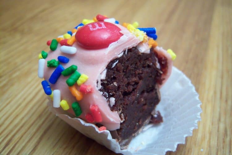 Cupcake bites with bite taken out pink frosting with sprinkles and red m&m