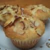 Lemon Ricotta Muffins topped with slivered almond on small white plate with gold stars and swirls