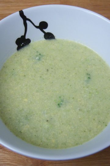 Broccoli Cheese Soup in round white bowl with black flowers