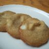 White Chocolate Macadamia Nut Cookies on small oval plate with small cat head