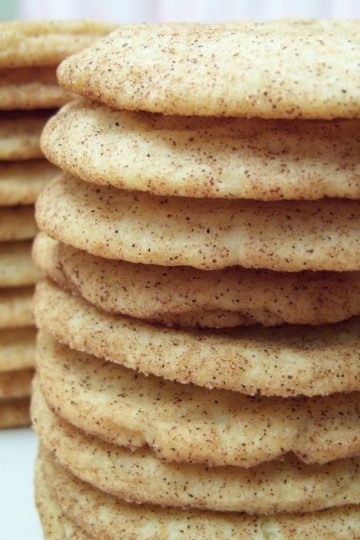 Snickerdoodle cookies in stacks on white oval plate