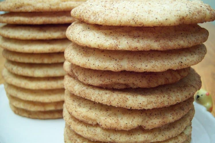 Snickerdoodle cookies in stacks on white oval plate