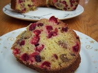 Cranberry nut bread sliced on round white plate