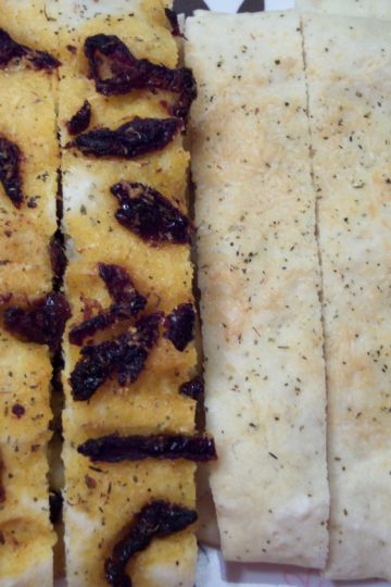 focaccia with no yeast topped with sun dried tomatoes and herbs and cheese