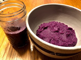 Purple sweet potato puree in a bowl and the purple sweet potato boiling liquid in a tall mason jar