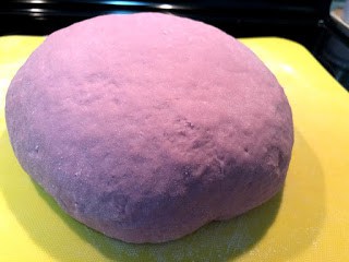 Purple sweet potato dough on yellow cutting board