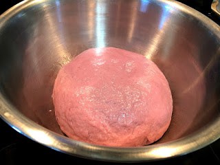 Purple sweet potato dough in metal bowl before proofing