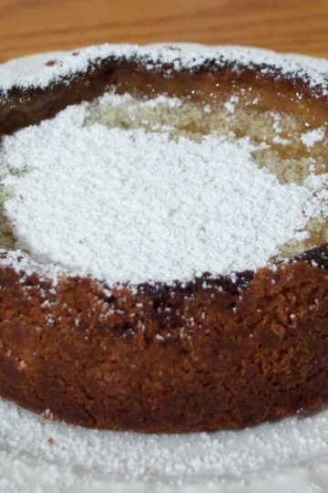 Tartest Lemon Tart with powdered sugar on round white plate