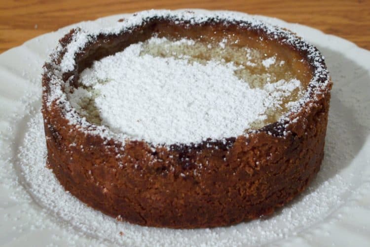Tartest Lemon Tart with powdered sugar on round white plate