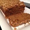 Pumpkin bread with streusel topping on white rectangular plate