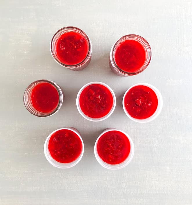 Strawberry lemon freeze jam in plastic freezer jam jars and glass mason jars