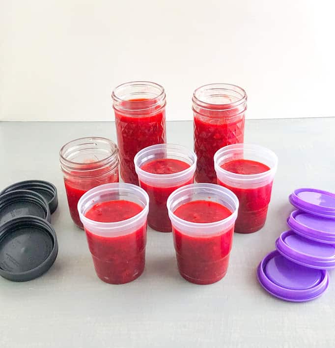 Strawberry lemon freeze jam in plastic freezer jam jars and glass mason jars, purple and gray lids