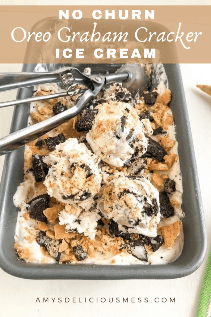 Frozen ice cream in loaf pan with crushed Oreo's and graham crackers on top. Topped with scoops of ice cream and cookie scoop in background