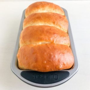 Bakes loaf of bread in silver loaf pan.