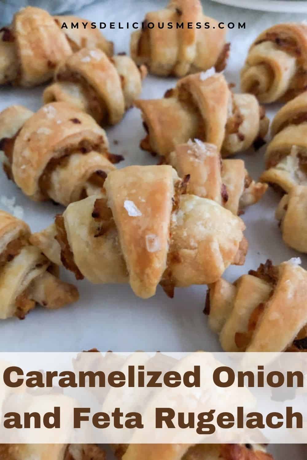 Baked rugelach arranged on top and next to each other on parchment paper.